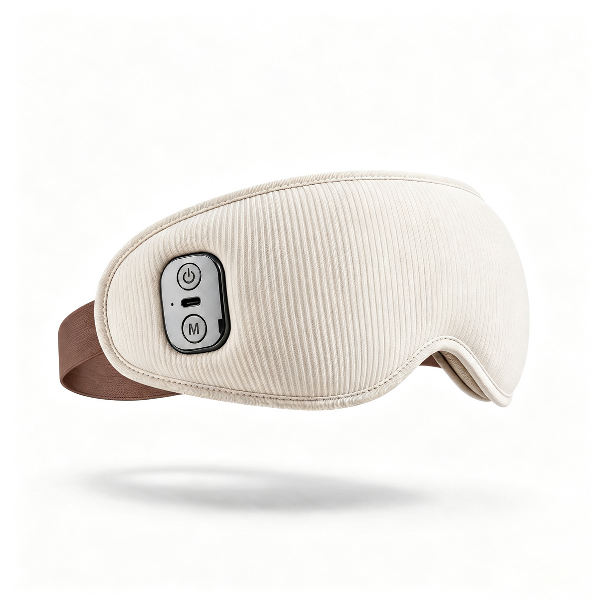 An electric eye mask massager in cream with a ribbed fabric texture, featuring a brown adjustable headband and a black control panel with white buttons on the side, shown against a plain white background with a soft shadow.