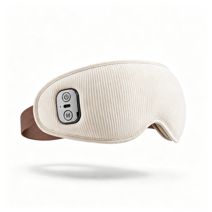An electric eye mask massager in cream with a ribbed fabric texture, featuring a brown adjustable headband and a black control panel with white buttons on the side, shown against a plain white background with a soft shadow.